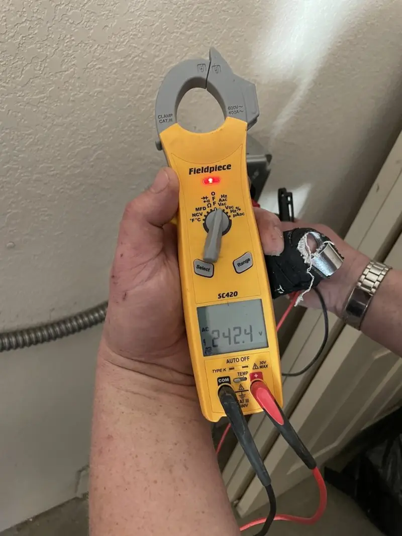 Voltage testing with clamp meter during Recessed Lighting Installation in Lillington
